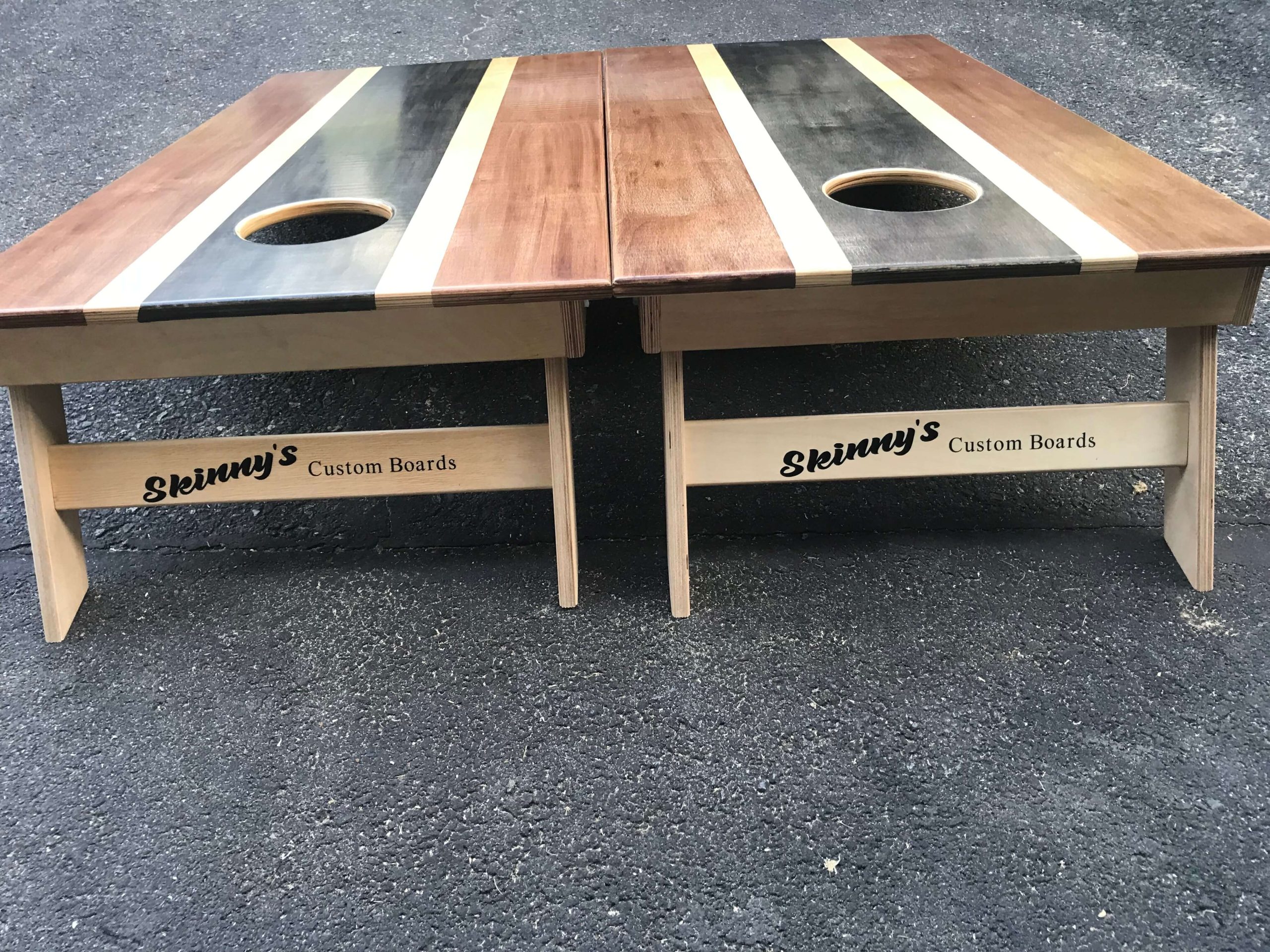 classic stripe cornhole boards with skinnys logo on it
